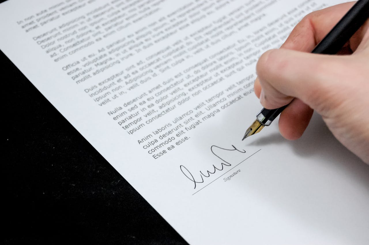 why-choose-us Close-up of a hand signing a debt settlement agreement